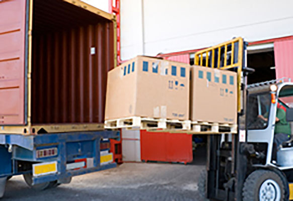 truck being loaded by fork lift